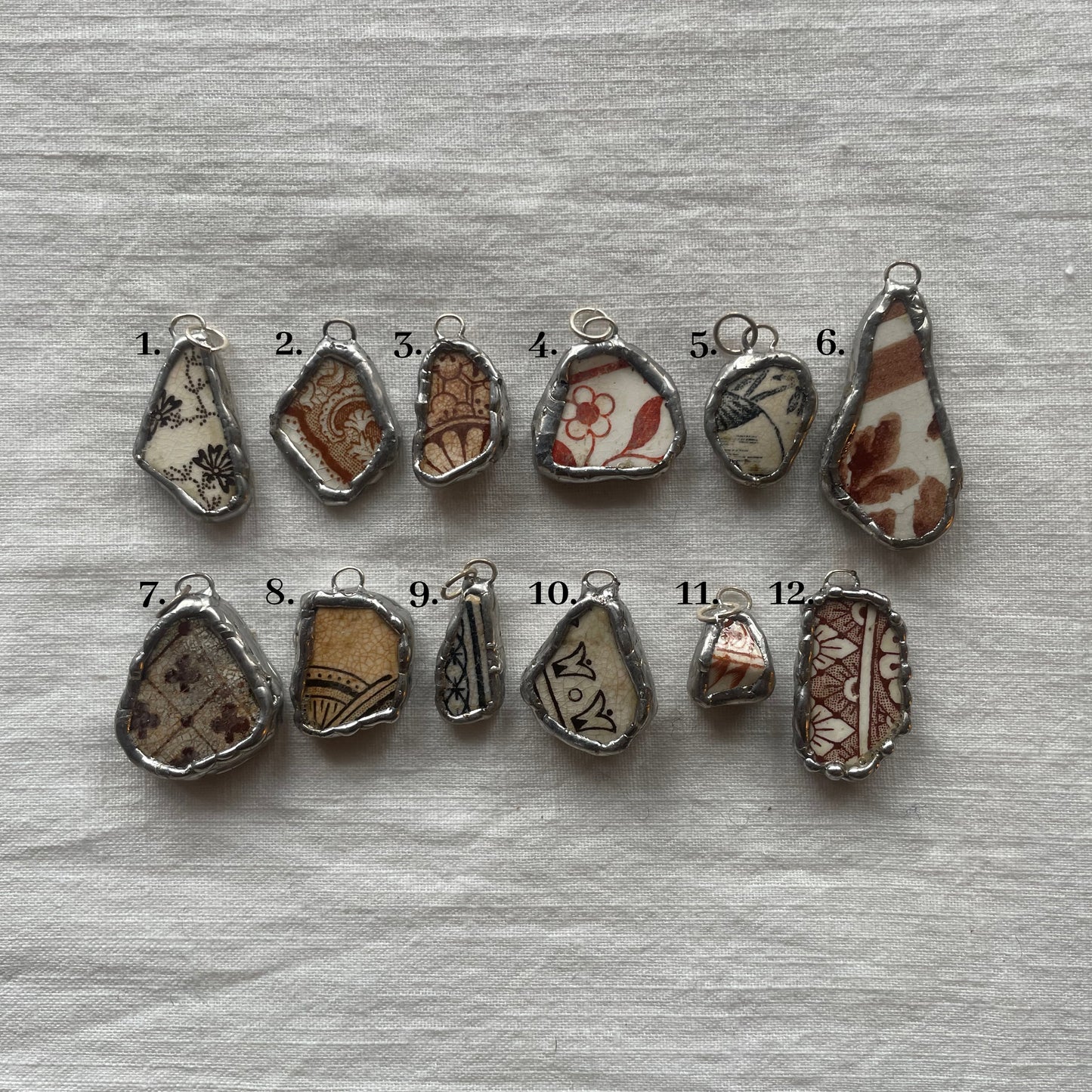 Sea pottery and silver pendant browns