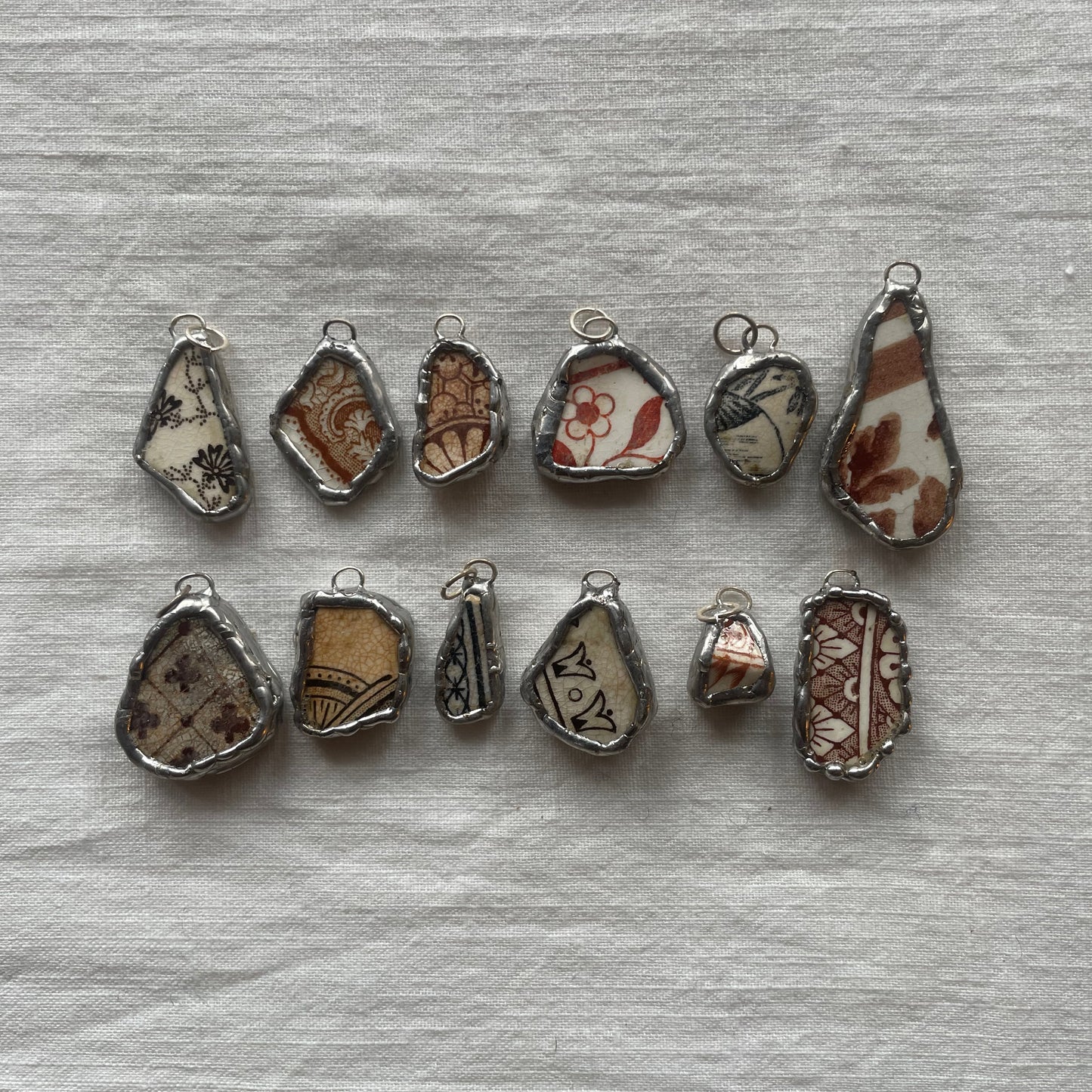 Sea pottery and silver pendant browns